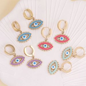 Detailed close-up of colorful evil eye hoop earrings with enamel finish on white plate