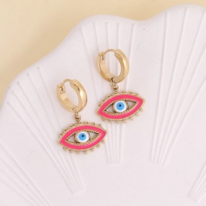 Chic gold devil eye earrings with pink enamel inlay displayed on a ceramic tray