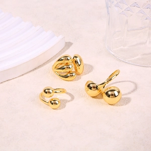 Minimalist gold geometric rings with spherical elements and smooth mirror polished finish