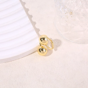 Detailed view of gold plated ocean element ring featuring polished double sphere geometric design