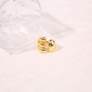 Macro detail of high-polish gold ocean element ring with organic crab claw design