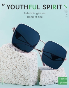 Detail of oversized square nylon sunglasses with rose gold metal frames on stone props
