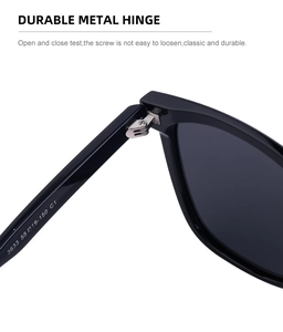 Detail view of reinforced metal hinge and model code on black oversized sunglasses