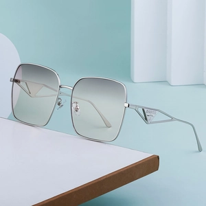 Oversized silver square metal sunglasses with green gradient lenses and hollow temple