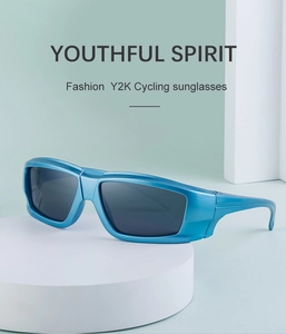 Close-up of blue metallic frame Y2K cycling sunglasses with dark lenses on a pedestal