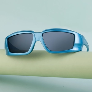 Macro shot of futuristic bright blue metallic windproof sports sunglasses on a stand