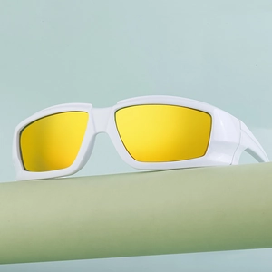 Close-up of white sports sunglasses with yellow mirrored lenses on a display stand