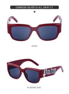 Détail de lunettes de soleil œil-de-chat rouges avec branches larges et logo Palm en métal