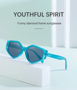 Detail view of stylish blue translucent geometric polygonal sunglasses on white display