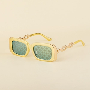Detail of square gold sunglasses featuring chain temples and patterned green lenses