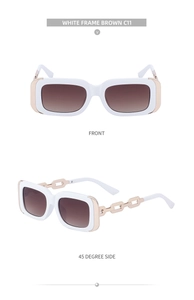 Detail view of white square sunglasses with gold chain temples and brown gradient lenses