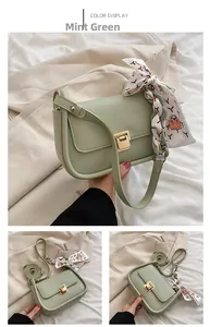 Detail view of cyan green PU leather flap bag featuring silk scarf handle and gold buckle