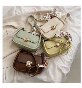 Detail of colorful crossbody square bags with elegant silk scarf and gold metal buckle