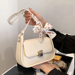 Cream white crossbody bag with gold buckle and red patterned silk scarf handle detail