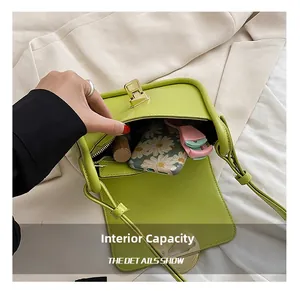 Internal capacity of neon green faux leather crossbody bag showing daily essentials