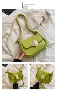 Detail view of green leather crossbody bag with round gold buckle and interior storage