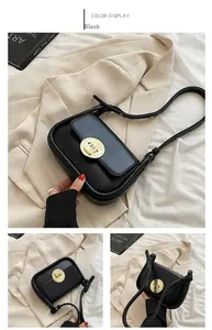 Detail of a black leather underarm bag featuring a vintage round golden twist lock closure