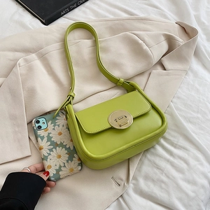 Minimalist light green faux leather baguette bag with round golden buckle closure