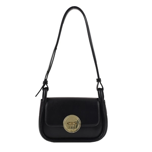 Chic black leather crossbody saddle bag featuring a minimalist golden circular metal clasp