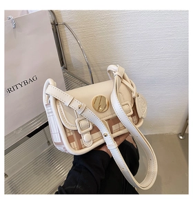 Detail of crossbody bag featuring cream leather texture and pink checkered woven pattern