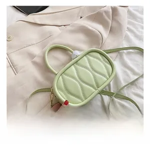 Detail of mint green quilted handbag with gold hardware and elegant textured surface