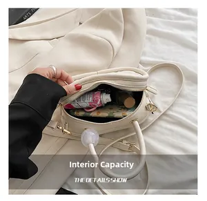 Internal capacity of off-white crossbody bag showing storage for essentials and makeup