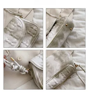 Detailed shot of crossbody bag featuring marble patterns, 3D quilting and gold hardware