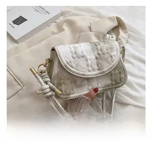Detail of light grey marble textured shoulder bag with unique biscuit embossed pattern