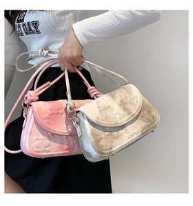 Detail of pink gradient and marble patterned underarm bags with 3D floral textures