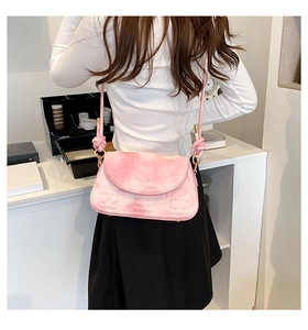Detail of pink marble pattern shoulder bag with gold clasp and knotted rope strap