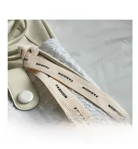 Detail of white embossed fabric texture with leather buckle and fashion strap on tote bag