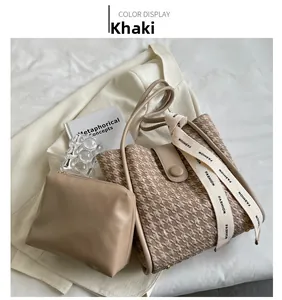 Detail of khaki houndstooth tote bag set with a wide fashion strap and matching pouch