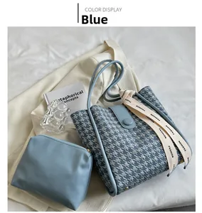 Close-up of blue houndstooth tote bag with matching pouch and stylish ribbon detail