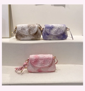 Close-up of mini crossbody bags with marble print and 3D bear embossing details