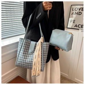Detail of blue houndstooth tote bag set with matching pouch and fashion ribbon
