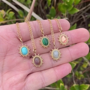 Detailed macro view of five vintage gold sunflower necklaces with colorful gemstones