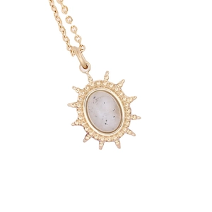 Golden sunburst pendant necklace with an oval translucent gemstone on a fine chain