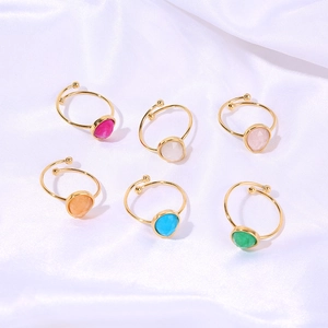 Set of six gold adjustable rings with colorful teardrop stones on white silk