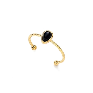Macro detail of hammered gold ring featuring a pear-shaped black stone setting