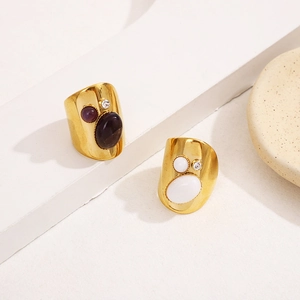 Detail of vintage gold plated rings with purple amethyst and white oval gemstones