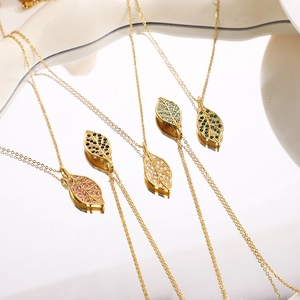 Elegant gold leaf pendant necklace set with colorful zircon stones on reflective base
