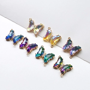 Detailed macro view of colorful butterfly crystal charms with gold-plated double loops