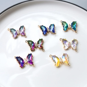 Close-up of colorful butterfly charms with zircon inlay and double hanging loops