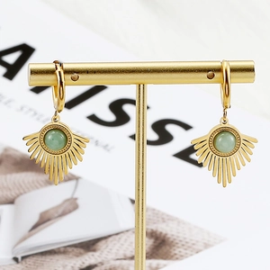 Detail of gold geometric earring with green gemstone on a T-shaped display stand