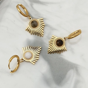 Detailed flat lay of three gold stainless steel sunray earrings with natural stones