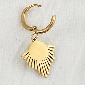 Detail of a gold stainless steel hoop earring featuring a sunburst geometric pendant