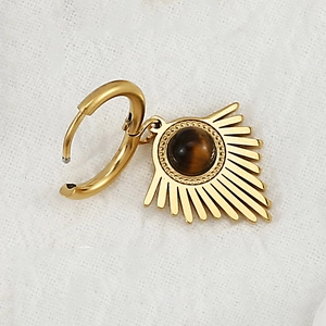 Detailed macro view of gold-plated stainless steel hoop earring with tiger eye stone