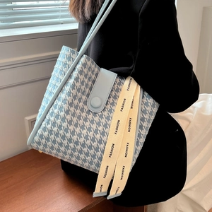 Blue and white houndstooth tote bag with light blue leather trim and fashion ribbons