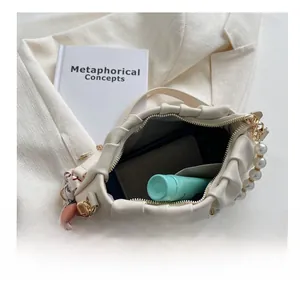 Interior view of white cloud bag showing spacious capacity for wallet and cosmetics