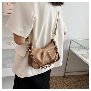 Detailed close-up of brown ruched cloud bag featuring chunky resin acrylic chain strap